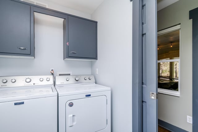 laundry room with cabinet space and washing machine and dryer