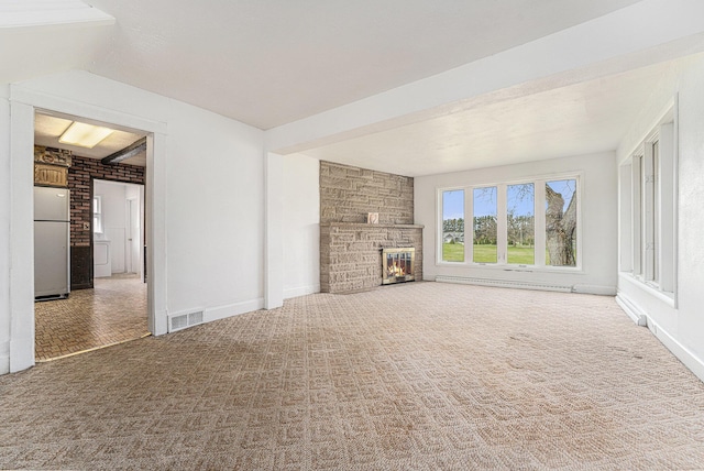 10145 W Kl Ave, Kalamazoo, MI 49009 - unfurnished living room featuring baseboards, visible vents, washer / dryer, and a fireplace