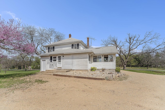 10145 W Kl Ave, Kalamazoo, MI 49009 - view of front facade featuring driveway and a chimney