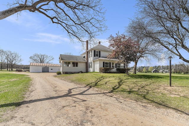 10145 W Kl Ave, Kalamazoo, MI 49009 - traditional style home with a chimney, a front lawn, and dirt driveway
