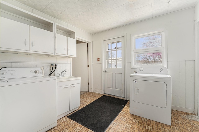 10145 W Kl Ave, Kalamazoo, MI 49009 - washroom with cabinet space, separate washer and dryer, and a sink