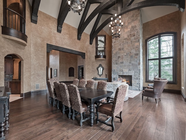 26565 Scenic, Franklin, MI 48025 - dining area featuring a fireplace, arched walkways, high vaulted ceiling, a chandelier, and dark wood finished floors