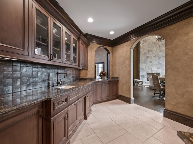 26565 Scenic, Franklin, MI 48025 - bar with backsplash, arched walkways, a sink, baseboards, and ornamental molding