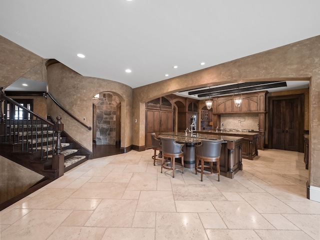 26565 Scenic, Franklin, MI 48025 - bar featuring stone tile floors, recessed lighting, a sink, and stairway