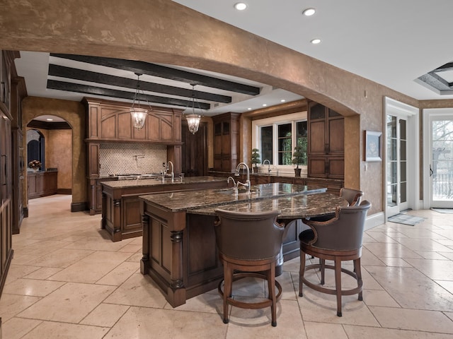 26565 Scenic, Franklin, MI 48025 - bar featuring arched walkways, hanging light fixtures, baseboards, recessed lighting, and stone tile floors