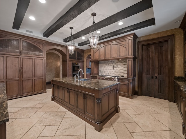 26565 Scenic, Franklin, MI 48025 - kitchen with stone tile floors, dark stone counters, arched walkways, a sink, and stainless steel appliances