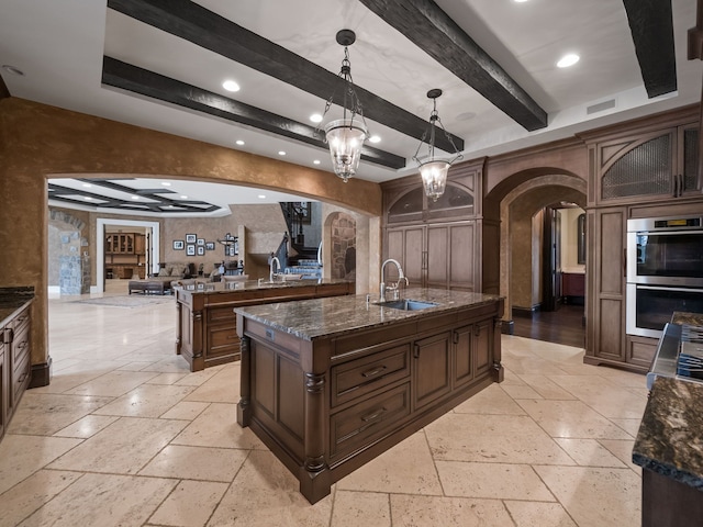 26565 Scenic, Franklin, MI 48025 - kitchen with arched walkways, double oven, and stone tile flooring