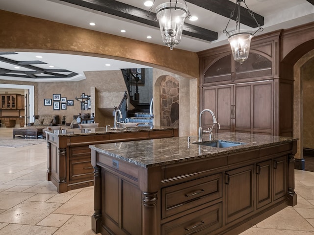 26565 Scenic, Franklin, MI 48025 - interior space with a sink, a raised ceiling, arched walkways, an island with sink, and open floor plan