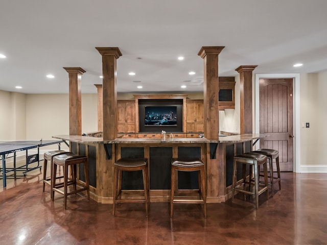 26565 Scenic, Franklin, MI 48025 - bar with concrete flooring, baseboards, indoor wet bar, ornate columns, and recessed lighting