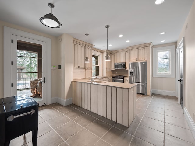 26565 Scenic, Franklin, MI 48025 - kitchen with plenty of natural light, appliances with stainless steel finishes, cream cabinets, baseboards, and a peninsula