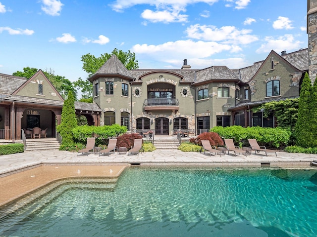 26565 Scenic, Franklin, MI 48025 - back of house featuring a balcony, a high end roof, an outdoor pool, stucco siding, and a patio area