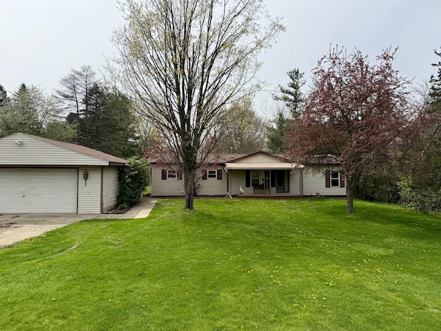 view of front of property featuring a porch, an outbuilding, a front yard, and a garage