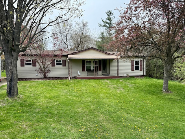 back of house with a porch and a yard