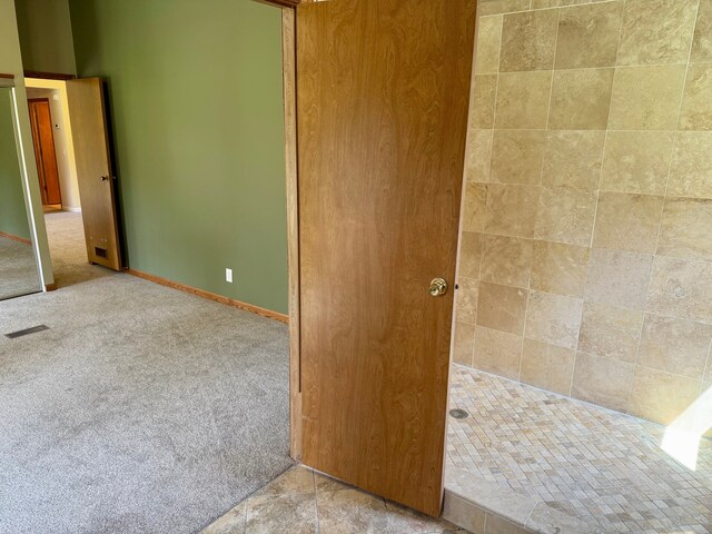 interior space featuring visible vents and a tile shower