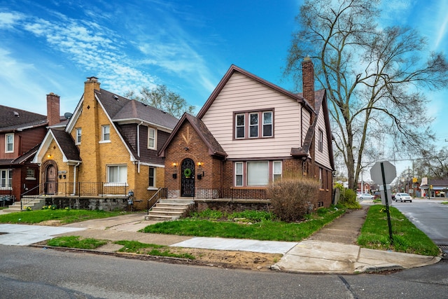 17215 Warrington Dr, Detroit, MI 48221 - tudor-style house featuring brick siding and a chimney
