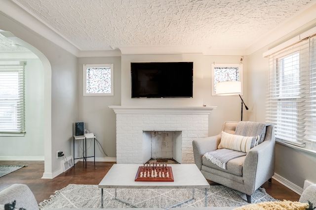 17215 Warrington Dr, Detroit, MI 48221 - living area with arched walkways, a textured ceiling, wood finished floors, and a fireplace