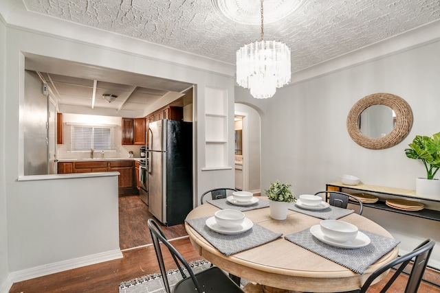 17215 Warrington Dr, Detroit, MI 48221 - dining room with dark wood-style flooring, arched walkways, baseboards, and an inviting chandelier