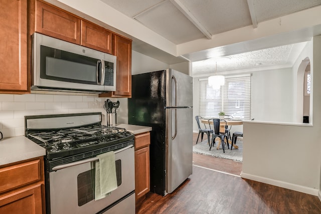 17215 Warrington Dr, Detroit, MI 48221 - kitchen featuring light countertops, stainless steel appliances, brown cabinetry, and a healthy amount of sunlight