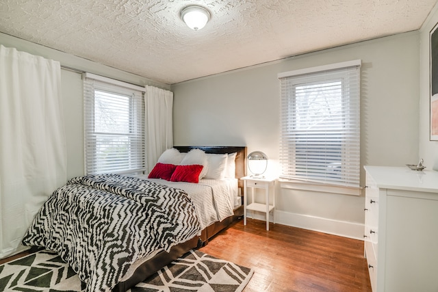 17215 Warrington Dr, Detroit, MI 48221 - bedroom with baseboards, a textured ceiling, and wood finished floors