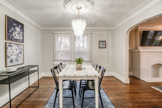 17215 Warrington Dr, Detroit, MI 48221 - dining space with arched walkways, a textured ceiling, a chandelier, and wood finished floors