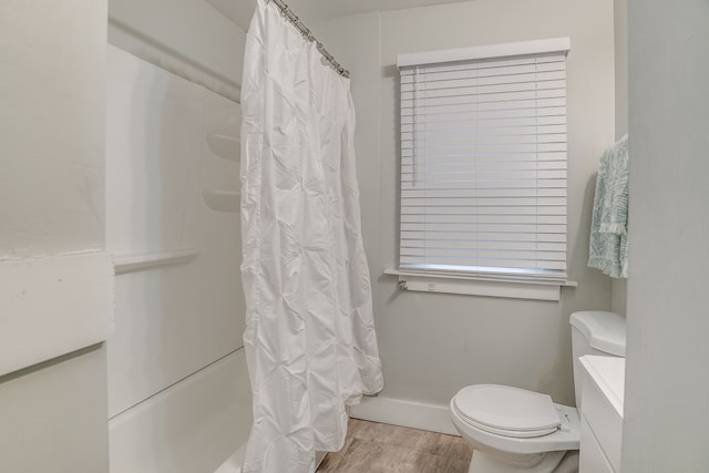 17215 Warrington Dr, Detroit, MI 48221 - bathroom featuring toilet, baseboards, wood finished floors, and shower / tub combo with curtain