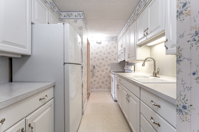21800 Morley Ave Unit 619, Dearborn, MI 48124 - kitchen featuring wallpapered walls, a textured ceiling, white appliances, a sink, and light countertops