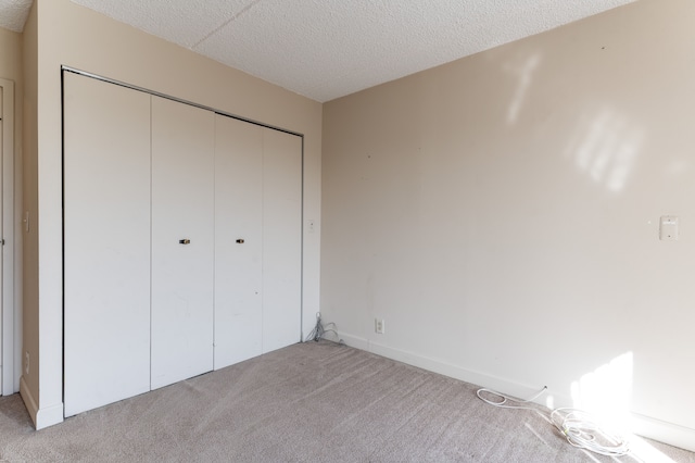 21800 Morley Ave Unit 619, Dearborn, MI 48124 - unfurnished bedroom with a textured ceiling, a closet, and light colored carpet