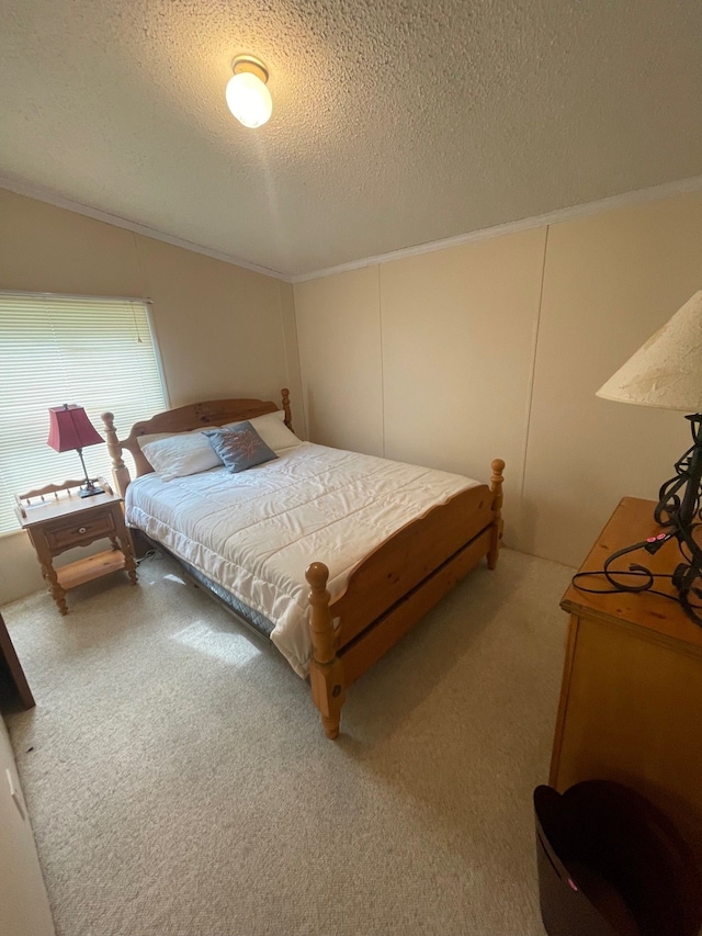 bedroom with crown molding, a textured ceiling, and carpet flooring