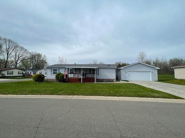 single story home with a porch, a garage, a front yard, and an outdoor structure
