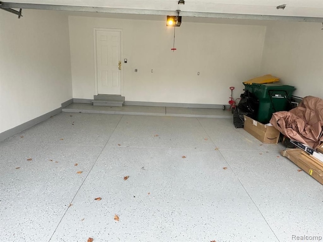 garage with baseboards and a garage door opener