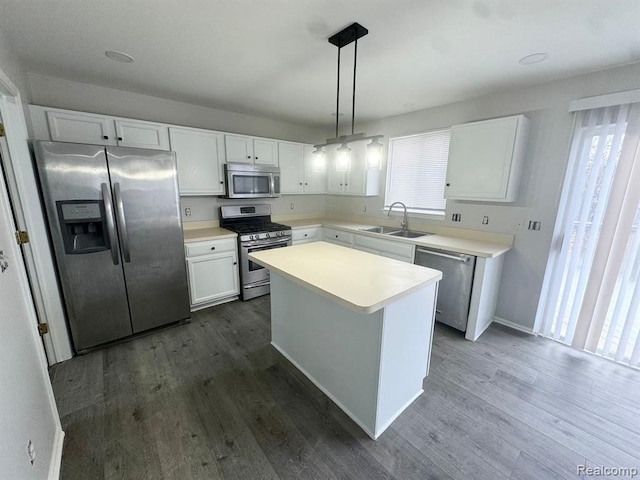 kitchen with a sink, white cabinets, a wealth of natural light, and stainless steel appliances