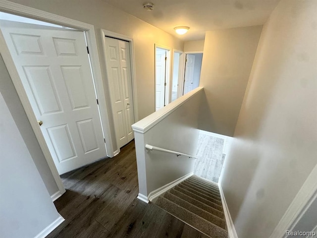 stairs featuring baseboards and wood finished floors