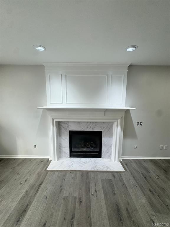interior details with baseboards, recessed lighting, wood finished floors, and a fireplace