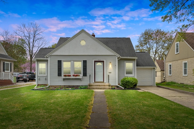 view of front of property featuring a chimney, roof with shingles, a front yard, and concrete driveway