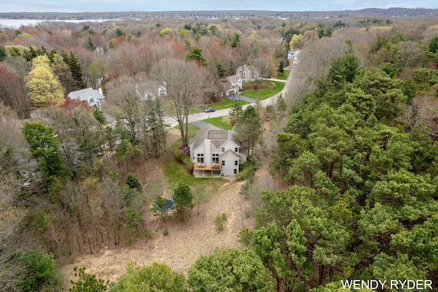 drone / aerial view with a wooded view
