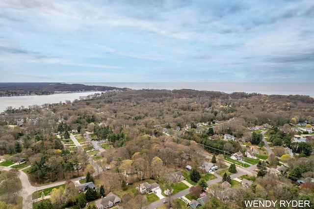 aerial view with a water view, a view of trees, and a residential view