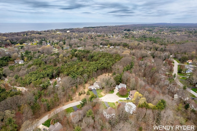 bird's eye view with a wooded view