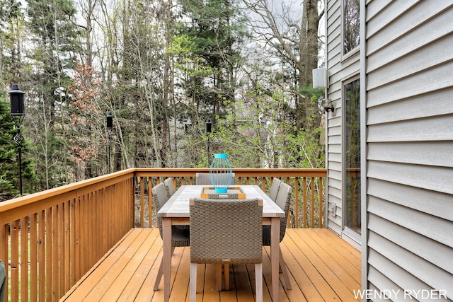 wooden deck featuring outdoor dining space
