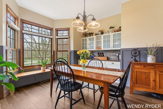 dining room with an inviting chandelier and wood finished floors
