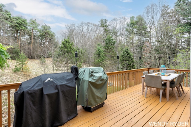 deck with grilling area and outdoor dining area