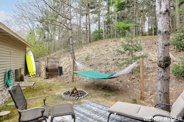 view of yard with an outdoor fire pit and fence