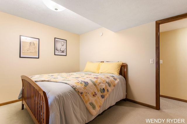 bedroom featuring baseboards and light colored carpet