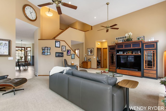 living room featuring baseboards, a ceiling fan, carpet flooring, and high vaulted ceiling