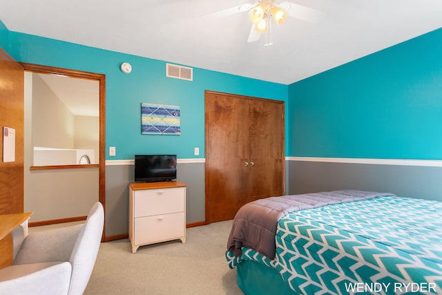 carpeted bedroom featuring a ceiling fan, baseboards, visible vents, and a closet
