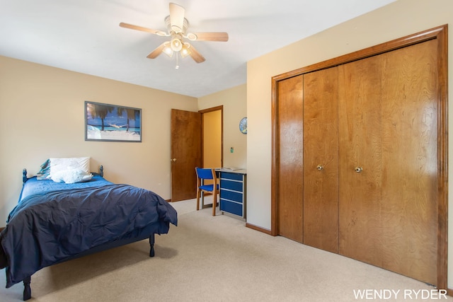 carpeted bedroom featuring a closet and a ceiling fan