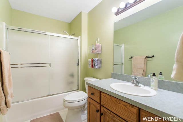 bathroom featuring vanity, tile patterned floors, toilet, and shower / bath combination with glass door