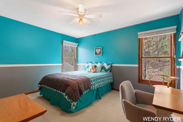 bedroom with baseboards, a ceiling fan, carpet floors, and multiple windows