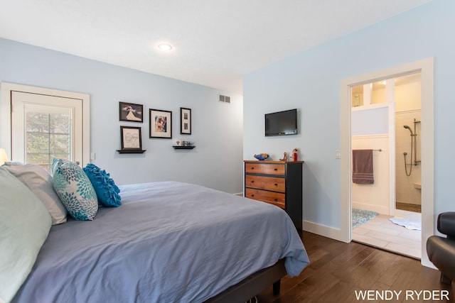 bedroom featuring baseboards, visible vents, dark wood-style floors, and ensuite bath
