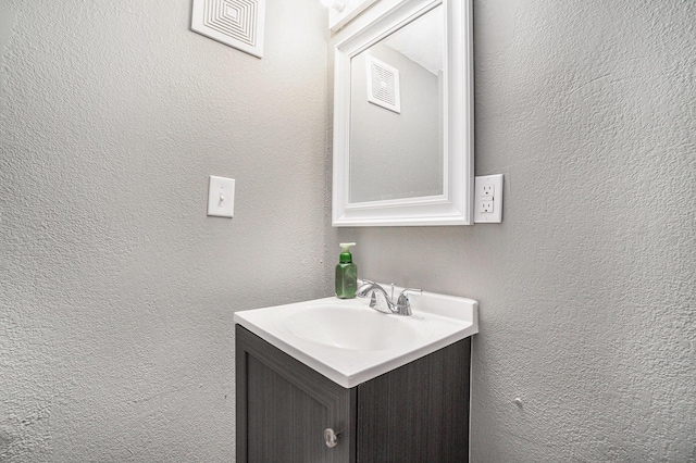 bathroom with vanity and visible vents