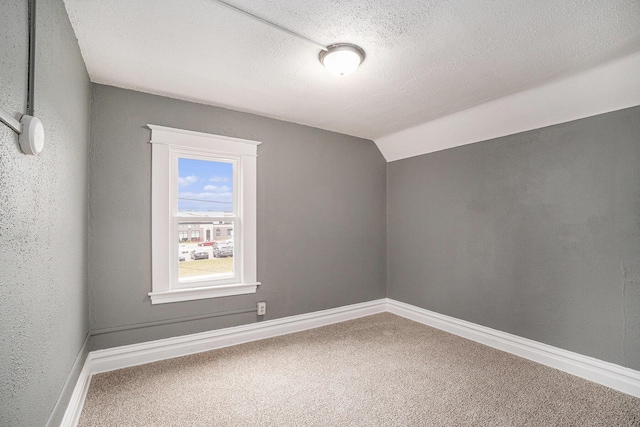 bonus room featuring baseboards, a textured ceiling, carpet, and lofted ceiling